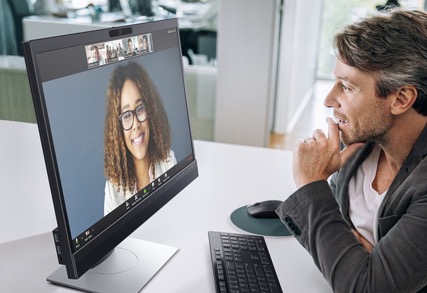 Business Man Sitting at Desk with P2418HZ Monitor